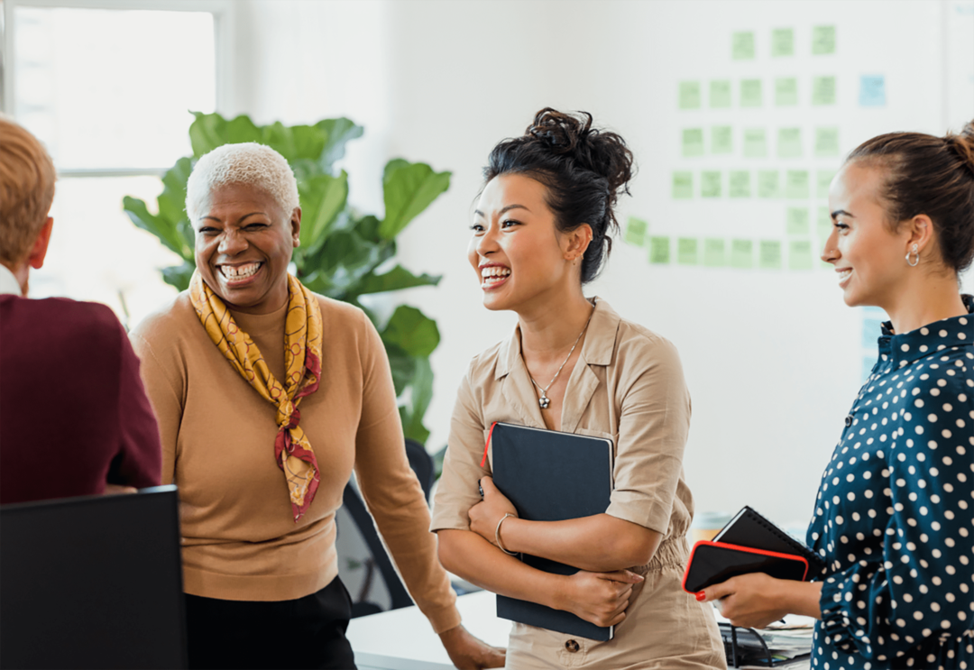 diverse group of women talking in office setting